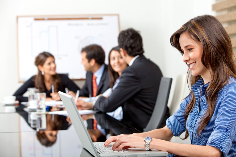 business woman on a laptop in a business meeting